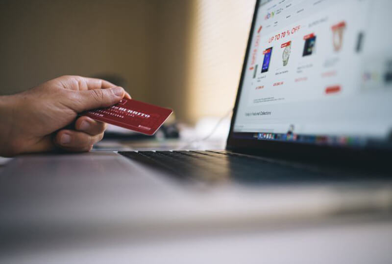 Man holding credit card to make online purchase